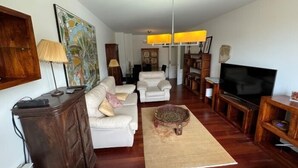 A living room with a sofa set, a coffee table, a TV, and a fireplace. - Rental unit in Liencres · ★New · 3 bedrooms · 3 beds · 2 baths (Liencres)