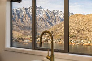 Enjoy breathtaking views of snow-capped mountains and a serene valley from this room's window.