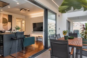 Enjoy a spacious living area with a balcony offering views of the surrounding buildings.