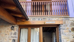 A stone building with a wooden balcony and a sign reading "CASAZALO". - Charming rural house Casa Zalo for 2-4 people in Mestas de Con (Cangas de Onís)