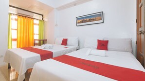 A hotel room with two beds, each with white bedding and red accents, a framed cityscape picture on the wall, and a window with yellow curtains. - Reddoorz Near Lrt 2 Antipolo Station (Antipolo)
