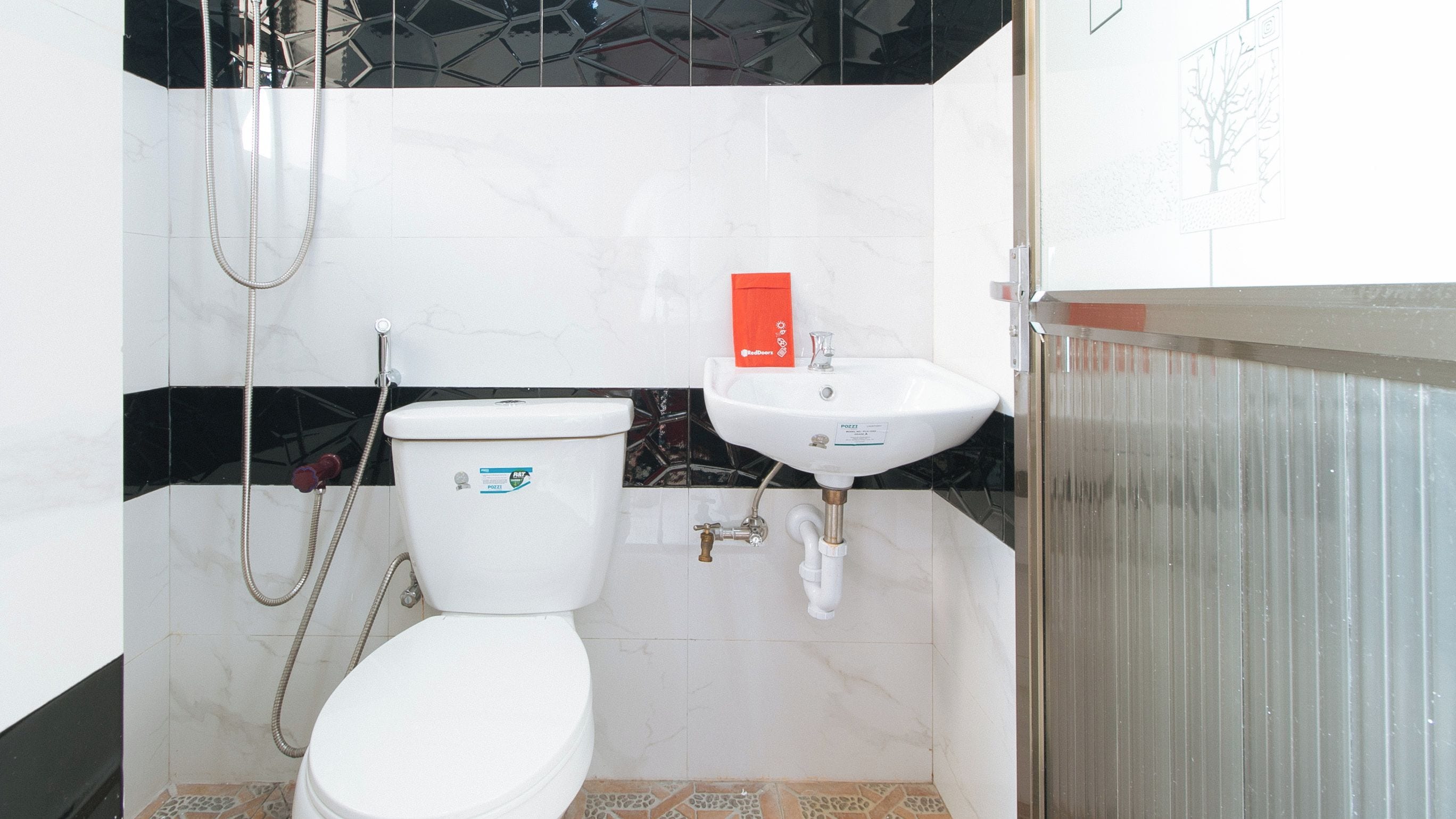 Un baño con inodoro, lavabo y ducha.