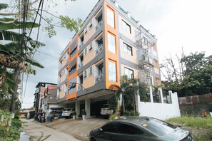A multi-story residential building with balconies, a covered parking area, and a gated entrance. - Reddoorz Near Lrt 2 Antipolo Station (Antipolo)