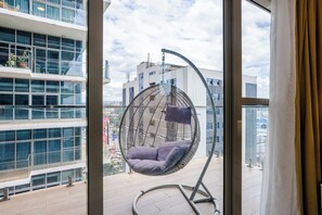 Relax in a comfortable seating area with a city view from the large window.