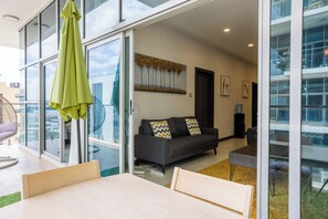 Relax in a spacious living area with a comfortable sofa and coffee table, leading to an outdoor space.