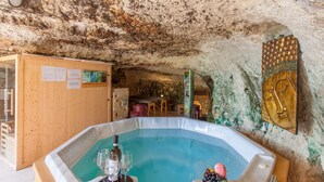 A hot tub in a cave-like setting with wooden walls and a mural. - Pool SPA - Wellness Villa St Martin (Mgarr)