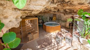 A spa area with a hot tub, wooden cabinets, and potted plants. - Pool SPA - Wellness Villa St Martin (Mgarr)