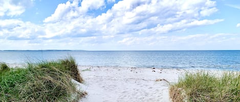 Beach nearby, white sand, sailing