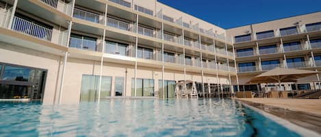 Indoor pool, outdoor pool, pool umbrellas, pool loungers