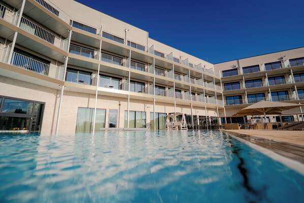 Indoor pool, outdoor pool, pool umbrellas, sun loungers
