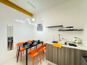 A modern kitchen with a dining area.