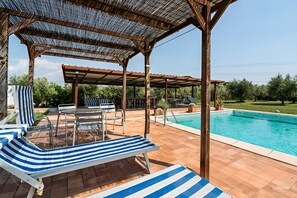 A covered outdoor area with a pool, lounge chairs, and a pergola. - AGRITURISM IL GIGLIO DI S.ANTONIO WITH GARDEN FOR ANIMAL AND PRIVATE POOL (Toscana)