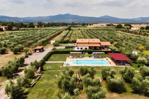 A villa with a swimming pool, surrounded by olive groves and a red-roofed pavilion. - AGRITURISM IL GIGLIO DI S.ANTONIO WITH GARDEN FOR ANIMAL AND PRIVATE POOL (Toscana)