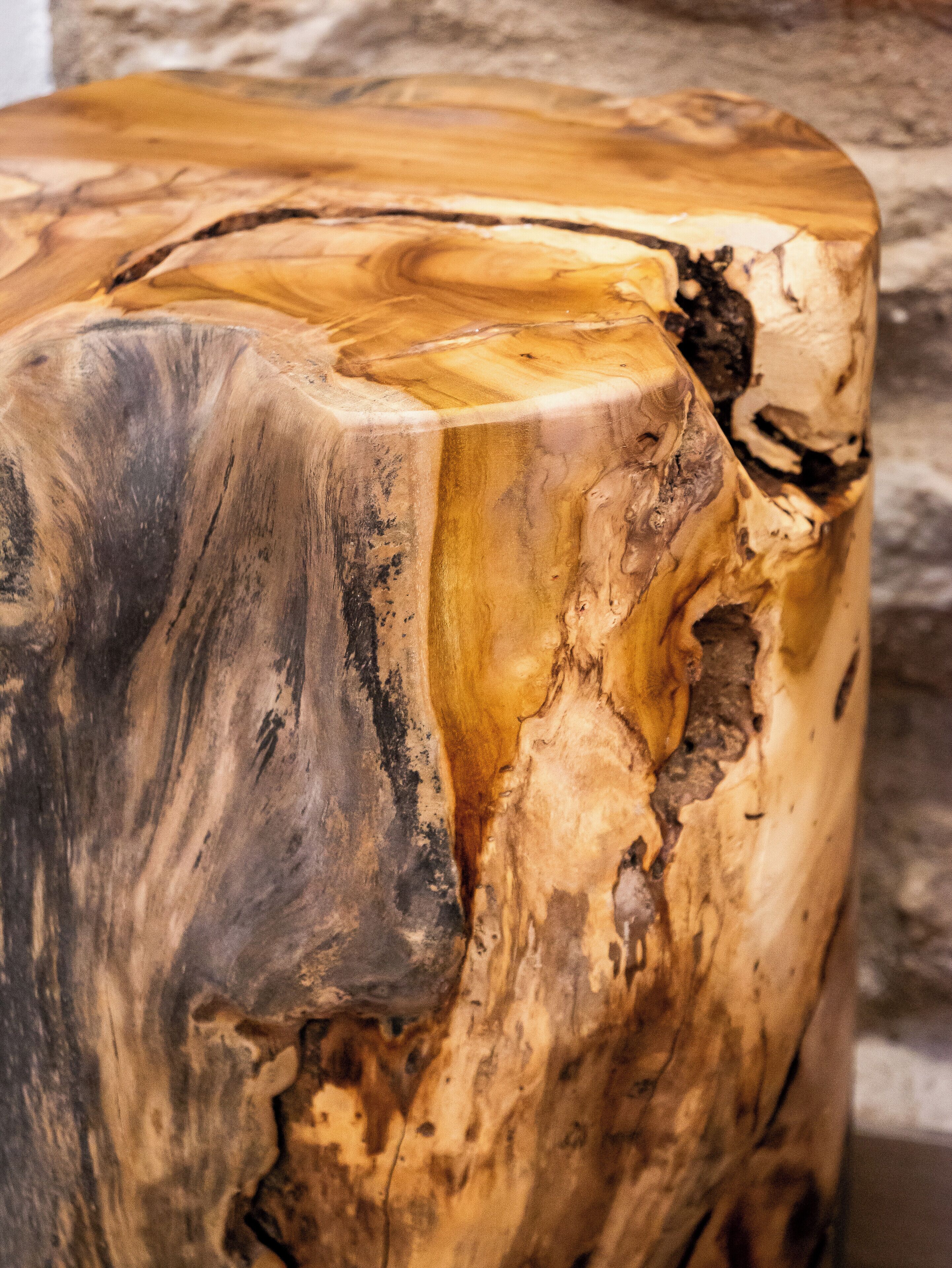 A close-up of a wooden table with a natural, uneven grain pattern.