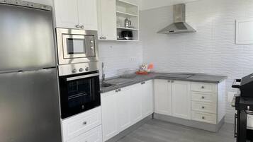 Deluxe Suite, 2 Bedrooms, Poolside | Private kitchen | Full-size fridge, microwave, oven, stovetop