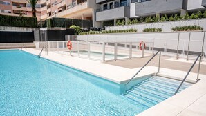 A swimming pool with clear water, surrounded by a white deck and metal railings. - Mijas Easy Flat With Pool - Ref 251 (Mijas)
