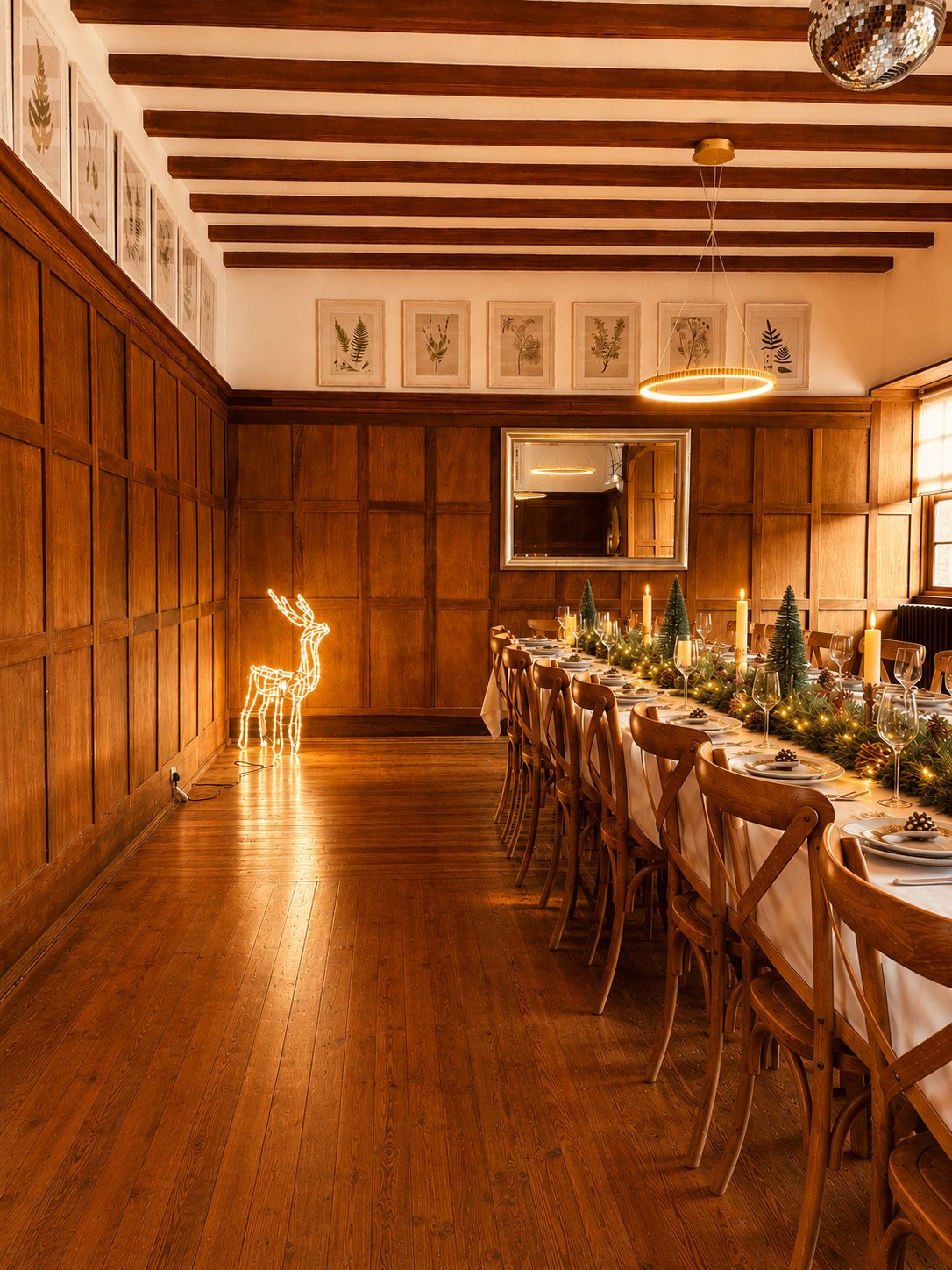 A dining area with wooden paneling, a long table set for a meal, and a chandelier.