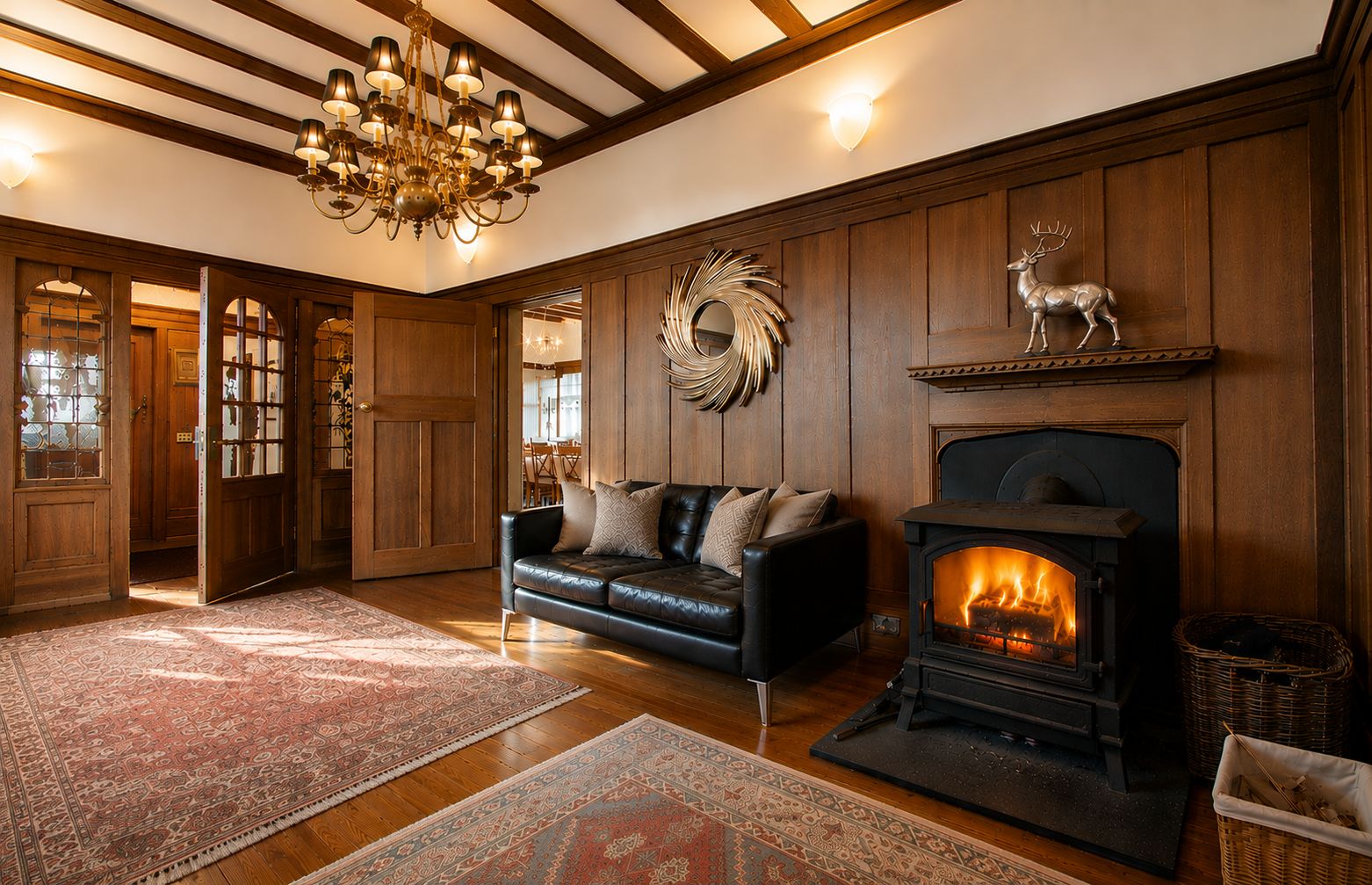 A cozy living room with a fireplace, a leather sofa, patterned rugs, and wooden paneling.