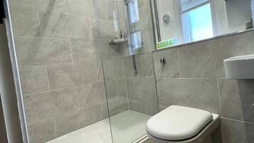 Shower, hair dryer, towels, shampoo