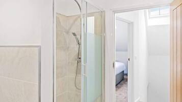 Shower, hair dryer, towels, shampoo