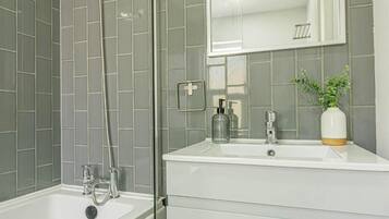 Shower, hair dryer, towels, shampoo