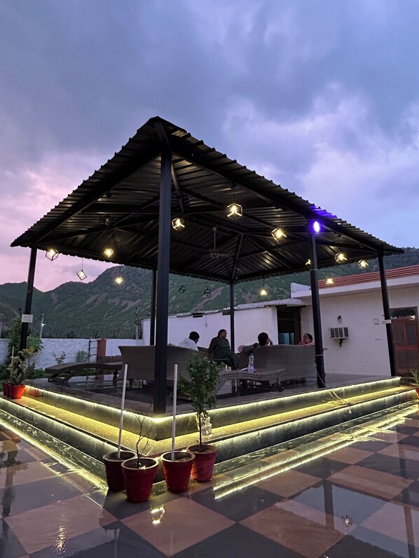 Terrace/patio - Nestled amidst majestic mountains, our farmhouse offers a serene and picturesque (Alwar)