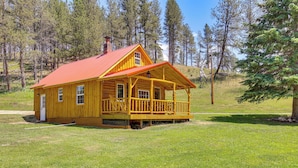 A wooden cabin with a red roof, a porch, and a chimney. - Remote Custer Cabin w/ Fire Pit & Near State Park! (Custer)