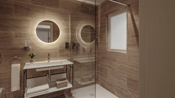 A modern bathroom with two round mirrors, a glass shower enclosure, and a white vanity.