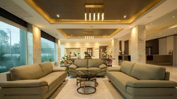 A modern living room with sofas, a coffee table, and a fireplace.