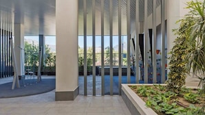 An indoor atrium with a high ceiling, large windows, and a view of a climbing wall. - Holiday Home with Pool by Costarentals - Ref 251 (Las Lagunas de Mijas)
