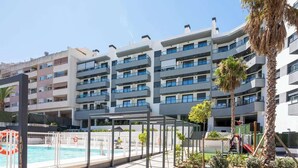 A modern multi-story hotel with balconies, a swimming pool, and palm trees. - Holiday Home with Pool by Costarentals - Ref 251 (Las Lagunas de Mijas)