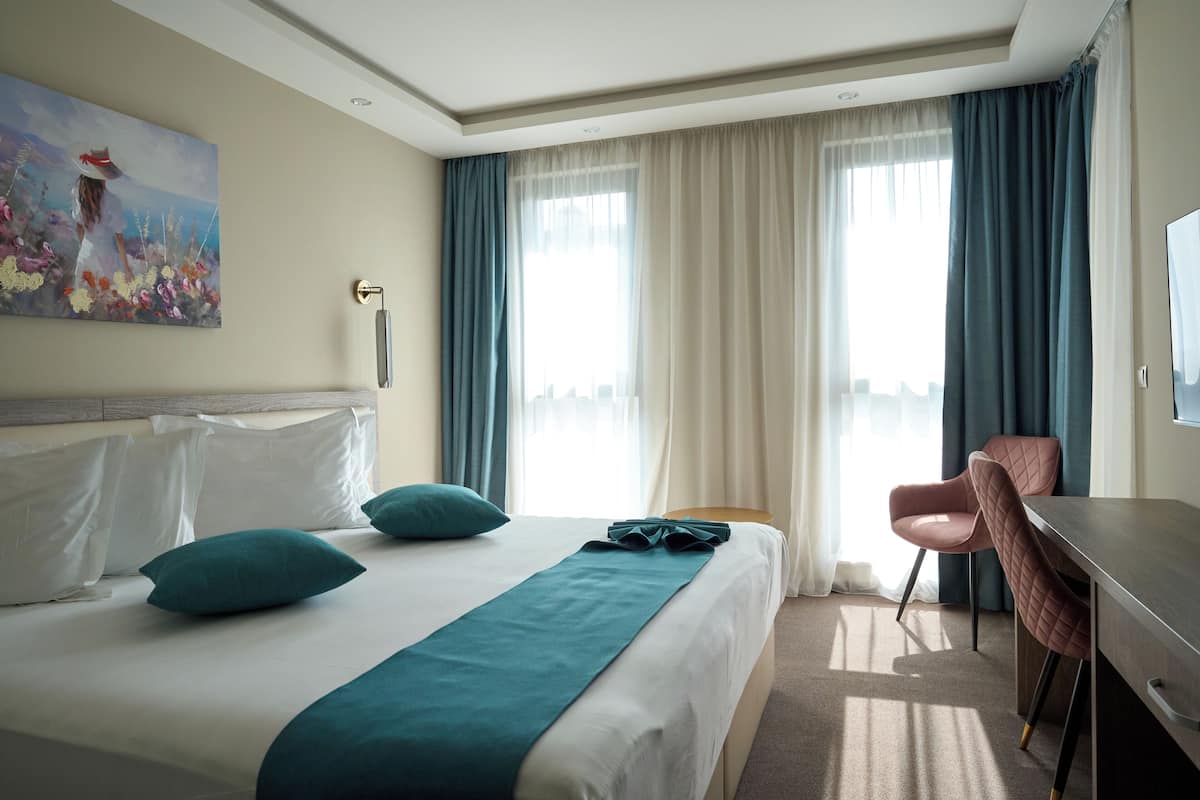 Deluxe Double Room with Balcony | In-room safe, desk, laptop workspace, blackout curtains