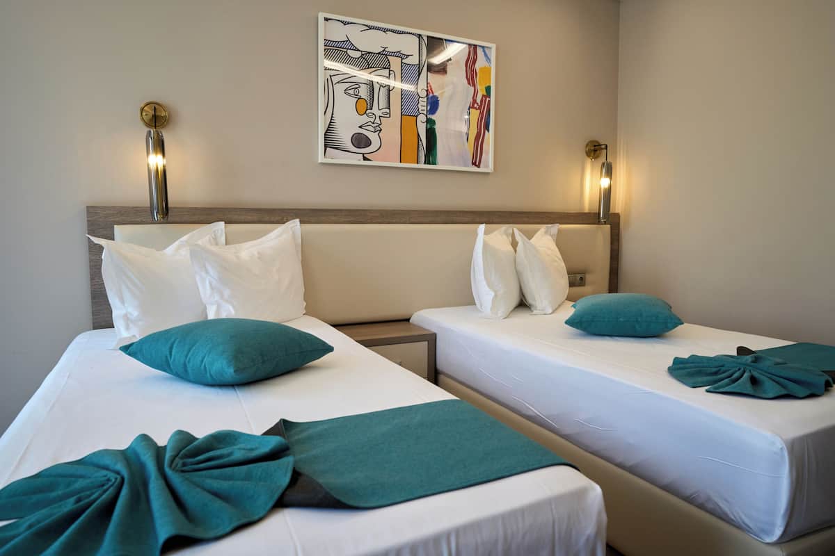 Twin Room with Balcony  | In-room safe, desk, laptop workspace, blackout curtains