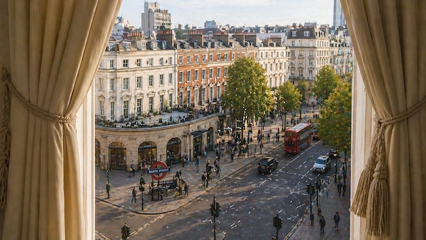 A view of Baker Street with historic buildings, a red double-decker bus, and pedestrians.