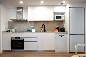 A modern kitchen with a built-in oven, microwave, and dishwasher.
