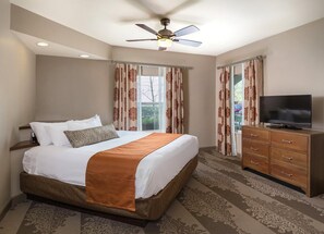 Relax in this inviting room with a large bed, flat-screen TV, and comfortable seating area.