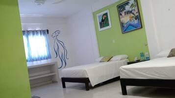 A hotel room with two beds, a ceiling fan, a window with curtains, and a wall with a painting.