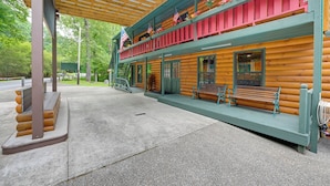 A log cabin with a covered porch and a second-story balcony with red railings. - 6 Mi to Town: Robbinsville Apt w/ Deck & Grill (Robbinsville)