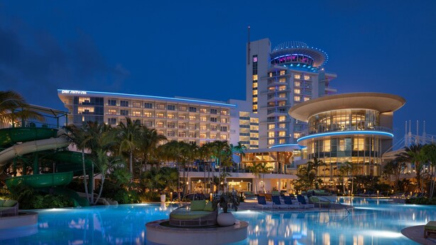 A hotel with a large pool, palm trees, and a water slide. - Pier Sixty-Six (Pier 66) (Fort Lauderdale)