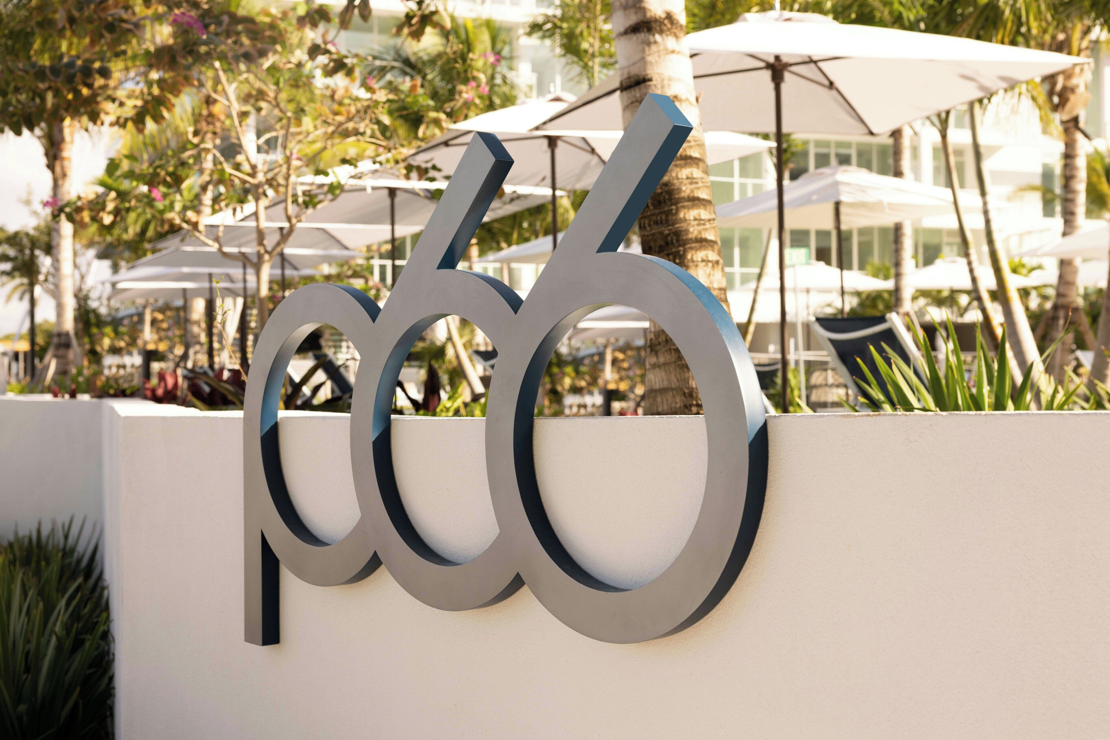 A modern building with a large metallic sign featuring the number '666'.