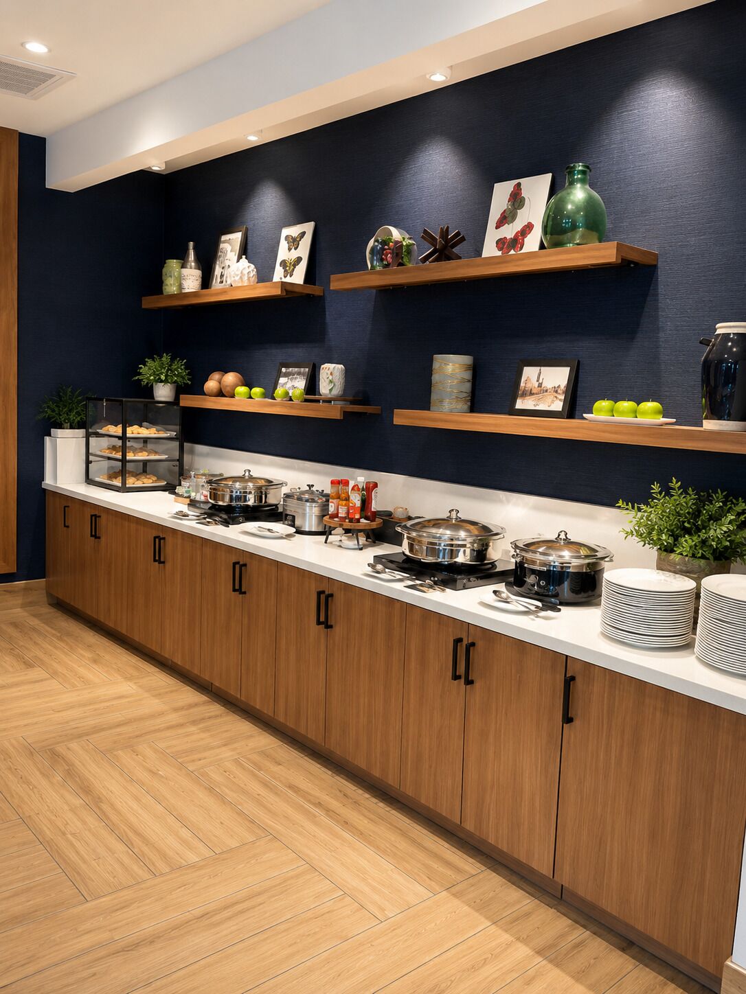 A kitchen with wooden cabinets, a countertop with various appliances, and decorative items on shelves.