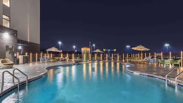 Seasonal outdoor pool, open 7:00 AM to 10:00 PM, pool umbrellas