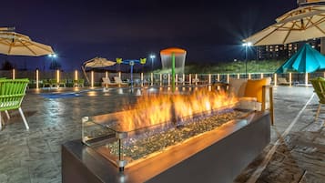 Seasonal outdoor pool, open 7:00 AM to 10:00 PM, pool umbrellas
