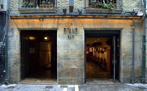 A stone building with two open entrances, one labeled "DAN BAR" and the other "RESTAURANT". - Casa Otano (Pamplona)