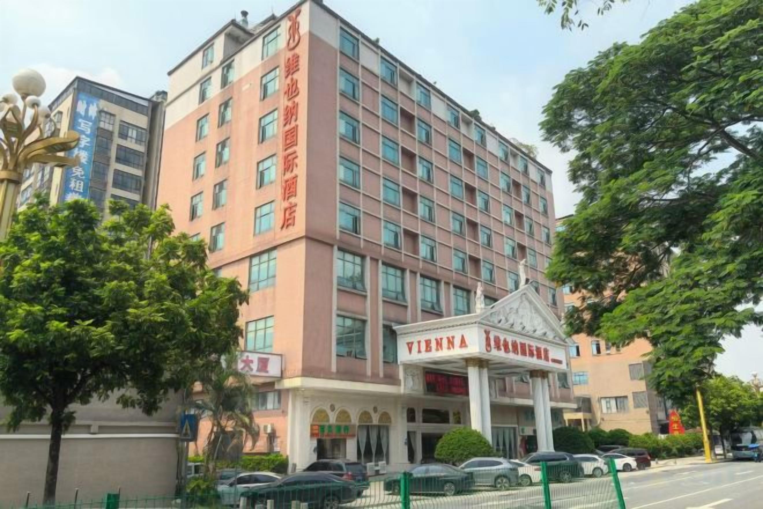 A multi-story hotel with a prominent entrance and signage.