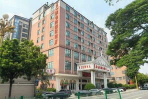 A multi-story hotel with a prominent entrance and signage.