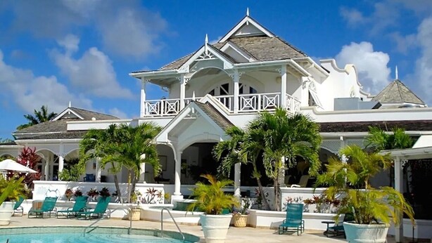 A large, white, two-story building with a pool in front. - Palm Breeze Condo, Sugar Hill near Holetown - Beach Club Membership (Mount Standfast)