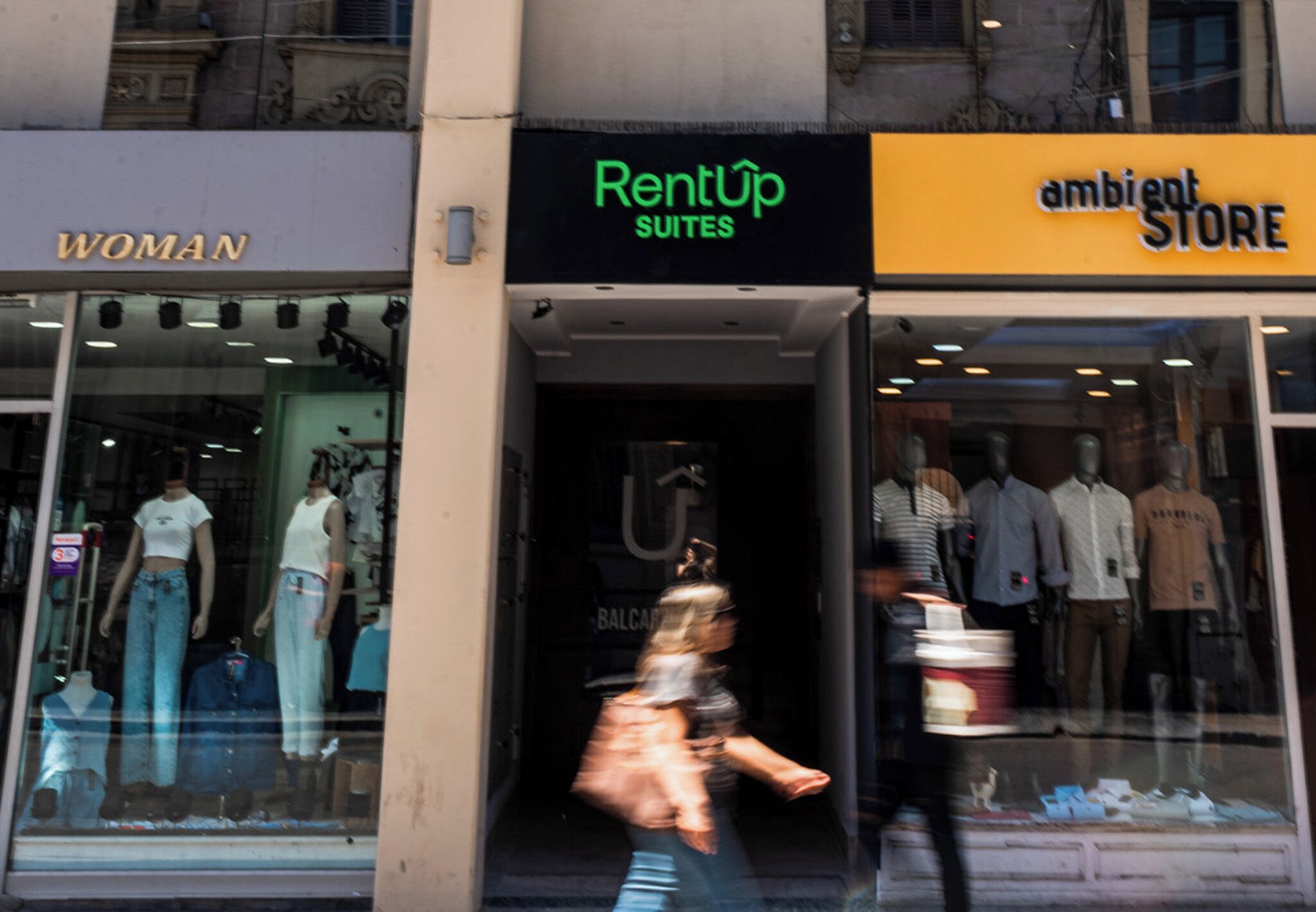 A storefront with 'RentUp Suites' and 'ambient STORE' signs.