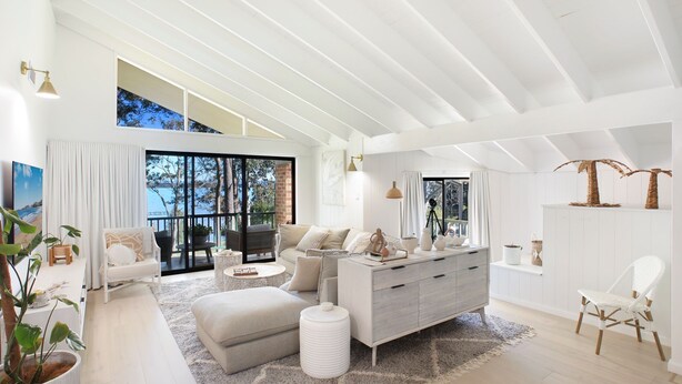 A spacious living room with a large window, a sofa, a coffee table, and a sideboard. - Waterfront Getaway, Kayaks included in stay - Kid Friendly (Sanctuary Point)