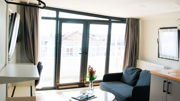 A modern living room with a sofa, a coffee table, and a television.